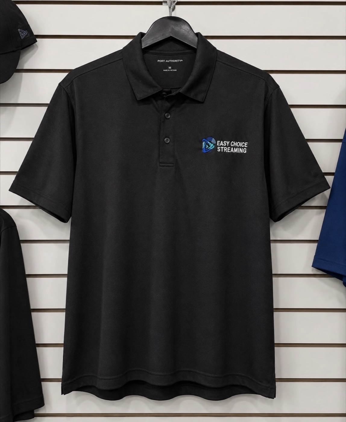 Black performance polo with the Easy Choice Streaming logo on the left chest