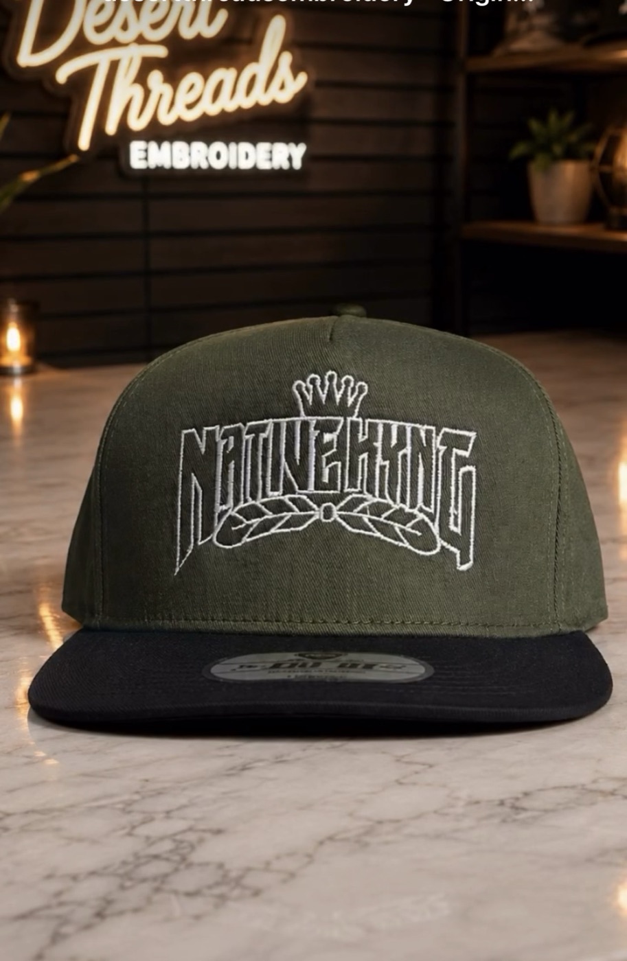 Olive and black snapback with a hand-punched NativeKing wordmark
